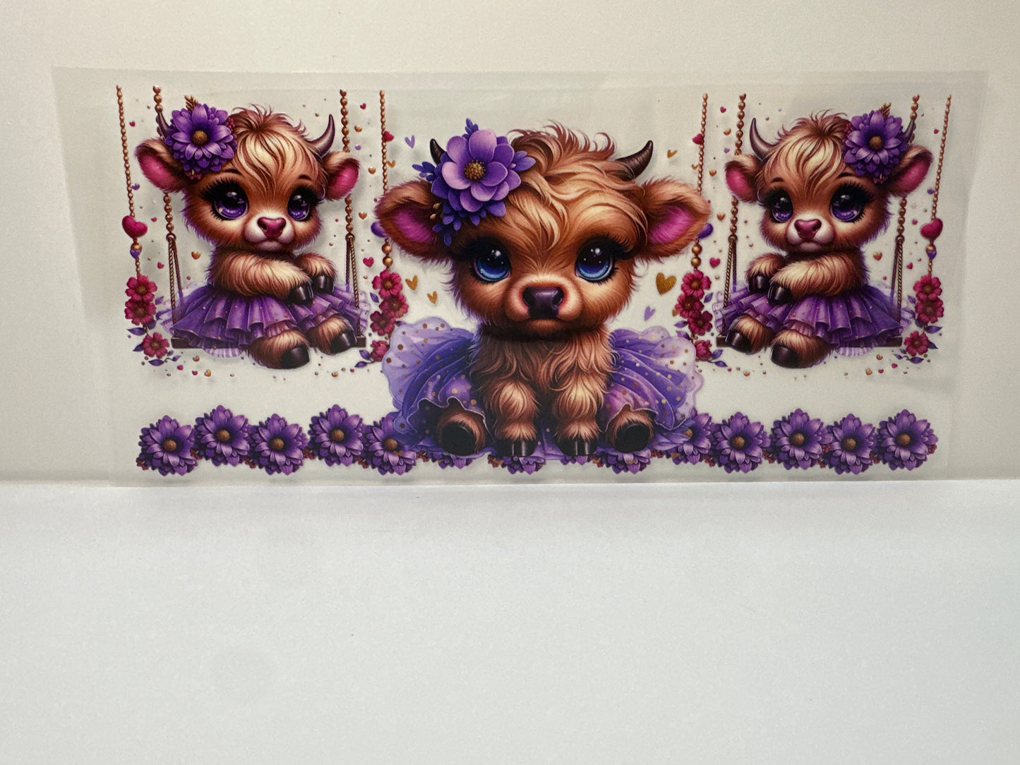 F438 cow on swing with purple tutu and flowers