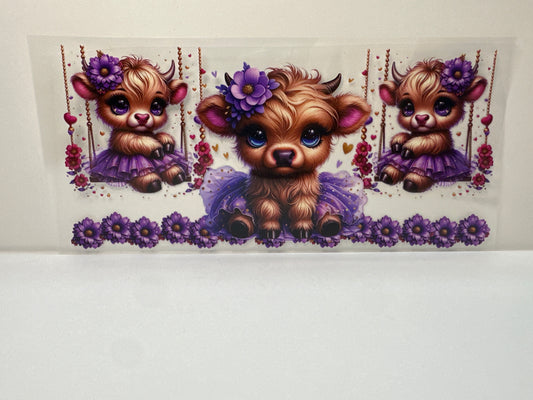 F438 cow on swing with purple tutu and flowers